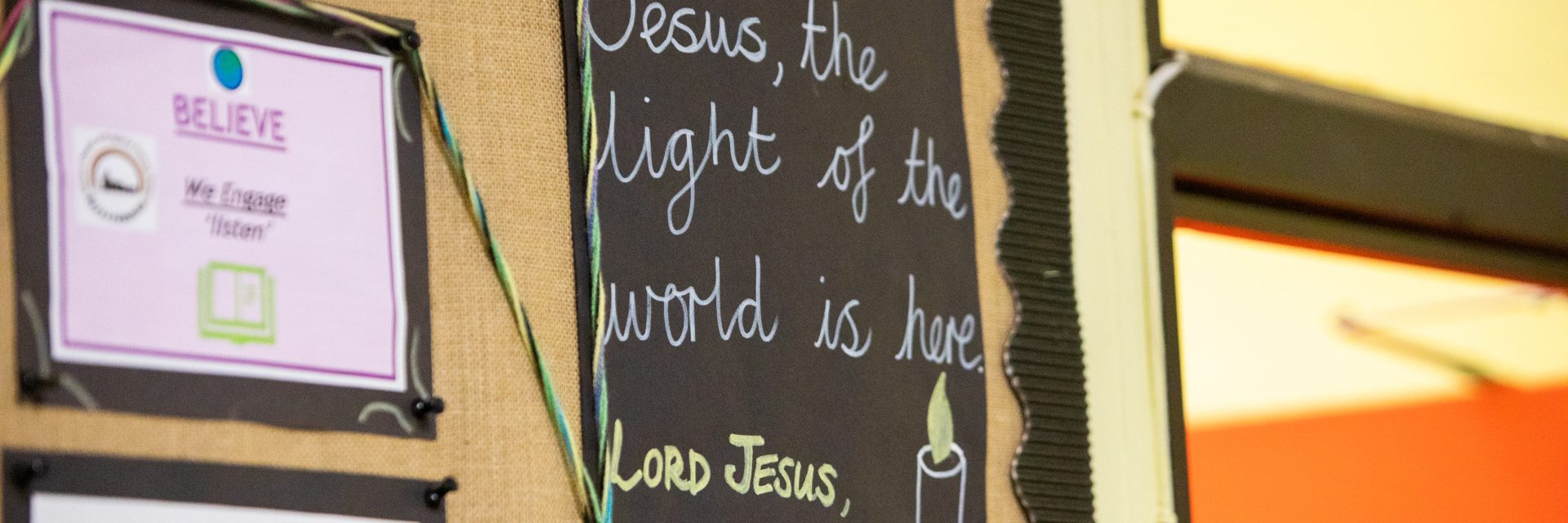 A poster at a school saying Jesus, the light of the world is here