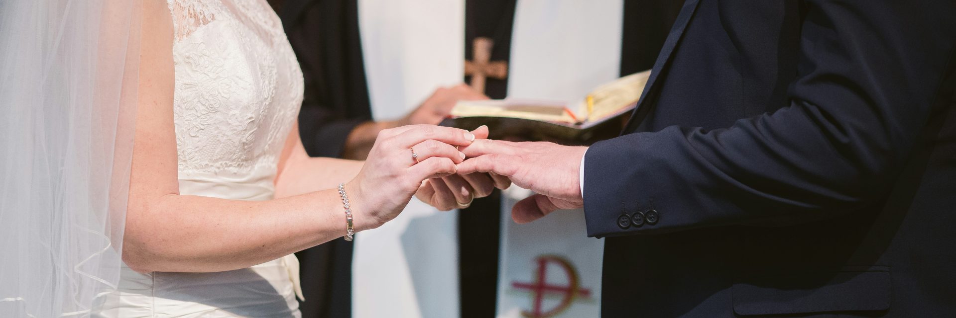 a man and woman exchanging rings at their wedding in a church